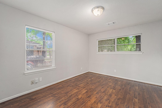 7433 Yoe St, Houston, TX 77016 - spare room with healthy amount of natural light, wood finished floors, and baseboards