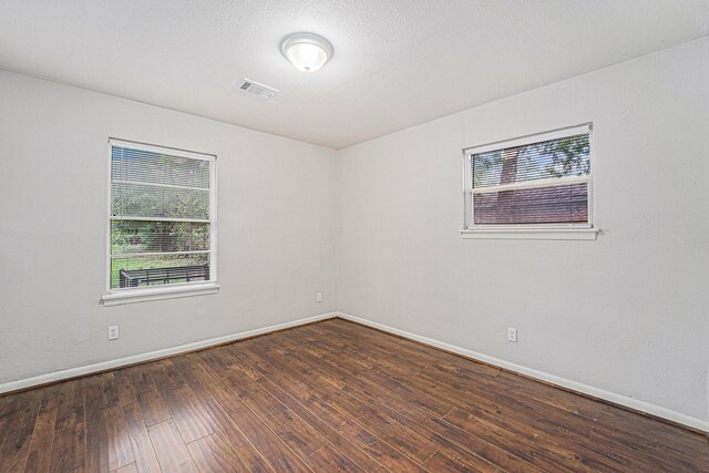 7433 Yoe St, Houston, TX 77016 - empty room featuring plenty of natural light, baseboards, and wood finished floors