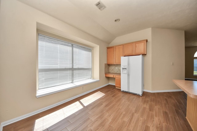 17127 Sheffield Pines Ln, Houston, TX 77095 - kitchen featuring white fridge with ice dispenser, light wood finished floors, tasteful backsplash, vaulted ceiling, and baseboards