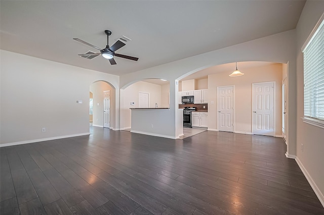 1526 Claremont Garden Cir, Houston, TX 77047 - unfurnished living room featuring a ceiling fan, dark wood-style flooring, baseboards, and arched walkways