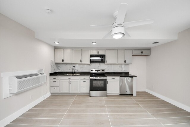 5903 Belneath St, Houston, TX 77033 - kitchen with black microwave, stainless steel range with electric stovetop, a sink, dark countertops, and a wall mounted AC