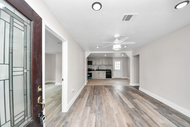 5903 Belneath St, Houston, TX 77033 - unfurnished living room featuring baseboards, light wood finished floors, a ceiling fan, and recessed lighting
