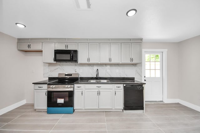 5903 Belneath St, Houston, TX 77033 - kitchen featuring black appliances, a sink, dark countertops, and baseboards