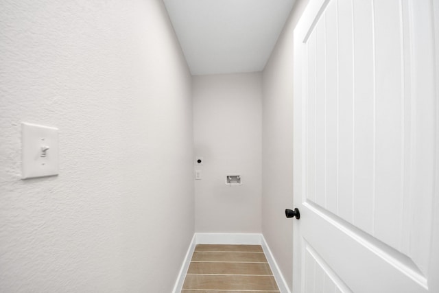 5903 Belneath St, Houston, TX 77033 - laundry room with hookup for an electric dryer, baseboards, wood finished floors, and washer hookup