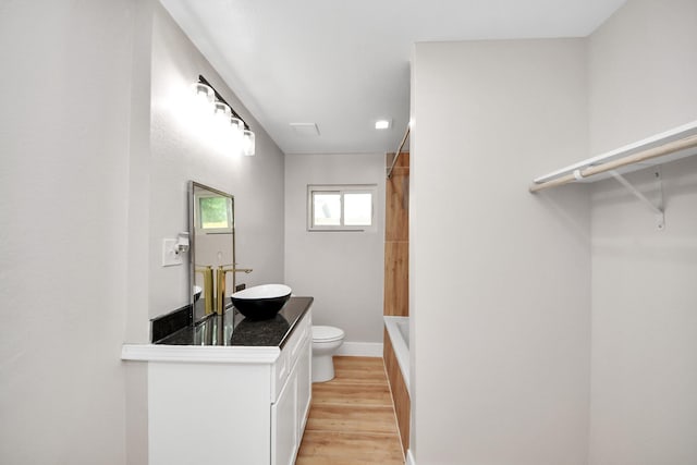 5903 Belneath St, Houston, TX 77033 - full bathroom with toilet, wood finished floors, vanity, bathtub / shower combination, and baseboards