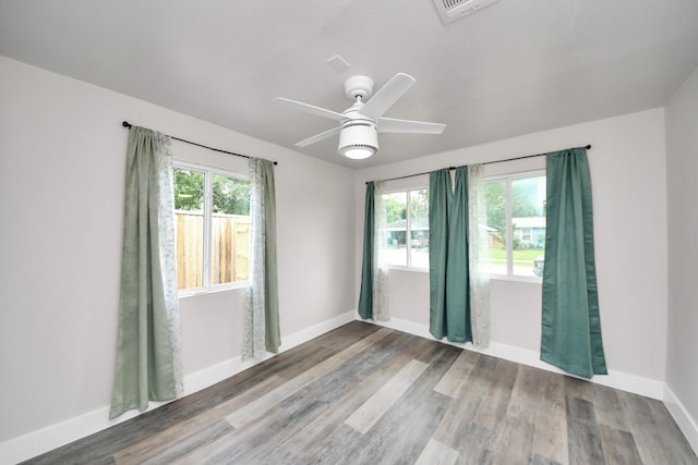 5903 Belneath St, Houston, TX 77033 - spare room featuring baseboards, wood finished floors, and a ceiling fan