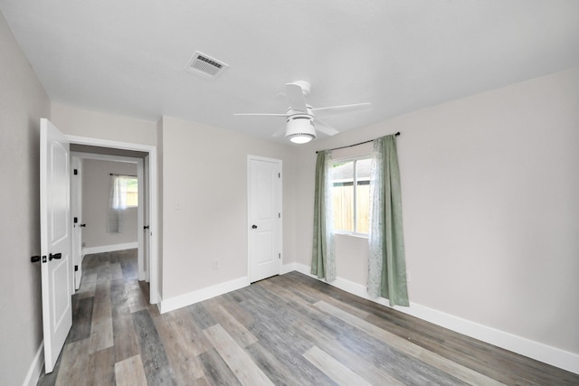 5903 Belneath St, Houston, TX 77033 - unfurnished bedroom featuring multiple windows, light wood-type flooring, and baseboards