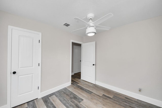 5903 Belneath St, Houston, TX 77033 - unfurnished bedroom featuring wood finished floors, baseboards, and a ceiling fan