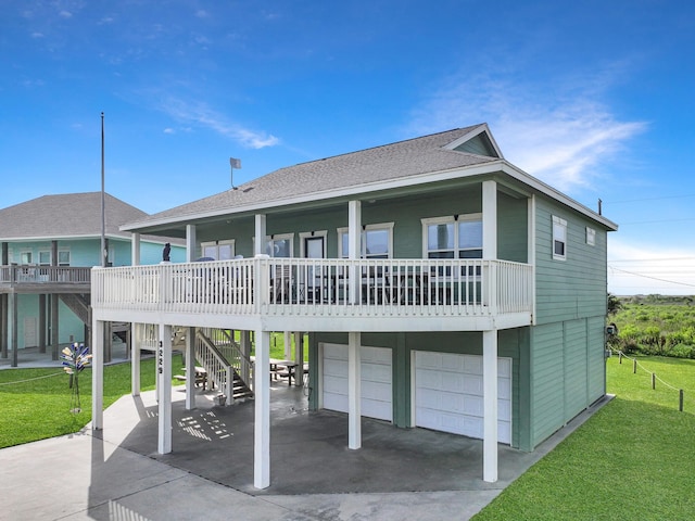 3229 Castle Dr, Crystal Beach, TX 77650 - view of front facade featuring a front yard, an attached garage, a shingled roof, and driveway