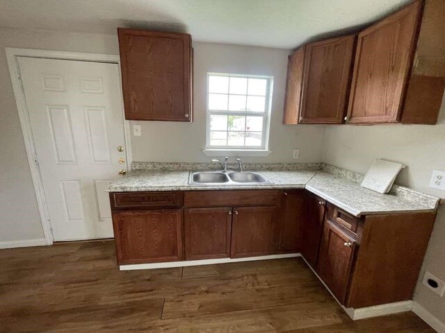 603 Willow St, Baytown, TX 77520 - kitchen featuring a sink, dark wood-style floors, light countertops, and brown cabinets