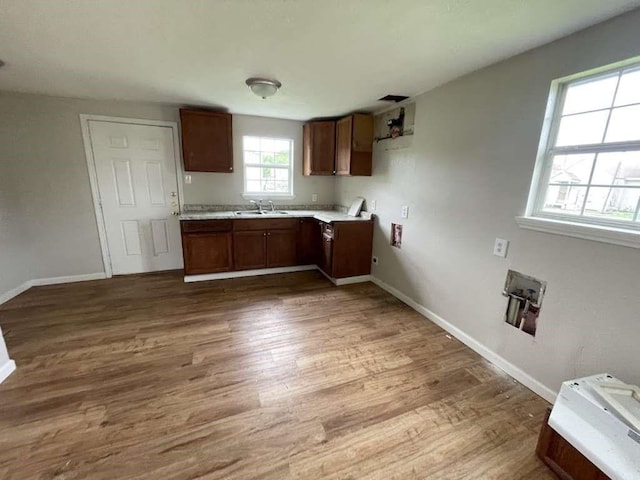 603 Willow St, Baytown, TX 77520 - kitchen featuring a sink, wood finished floors, baseboards, and light countertops