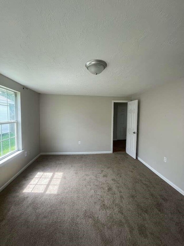 603 Willow St, Baytown, TX 77520 - carpeted spare room with a textured ceiling and baseboards