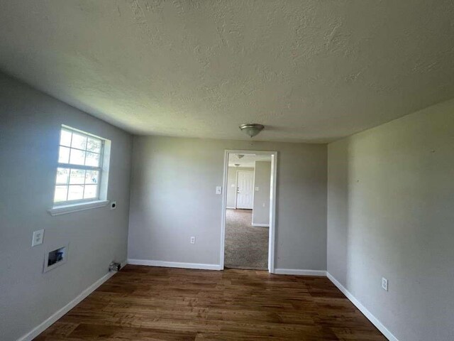 603 Willow St, Baytown, TX 77520 - spare room with a textured ceiling, baseboards, and wood finished floors