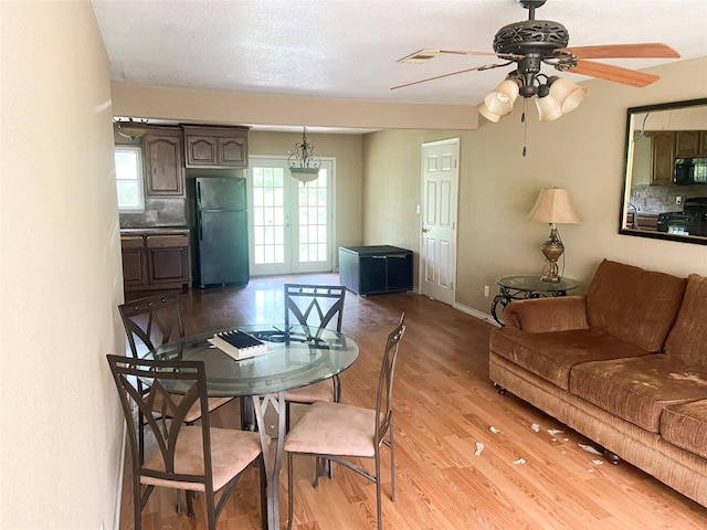 340 Warner St, Bridge City, TX 77611 - dining room with light wood-style flooring, ceiling fan, and baseboards