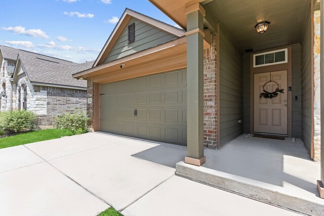 3221 Climbing Gardens Ct, Conroe, TX 77301 - property entrance with brick siding, a shingled roof, concrete driveway, and an attached garage