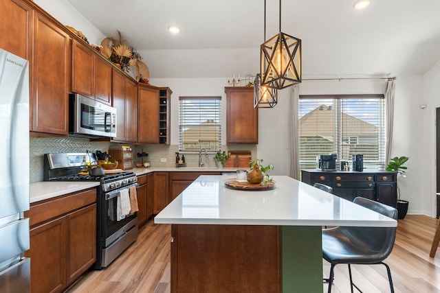 3221 Climbing Gardens Ct, Conroe, TX 77301 - kitchen featuring appliances with stainless steel finishes, light wood-style floors, a sink, decorative backsplash, and recessed lighting