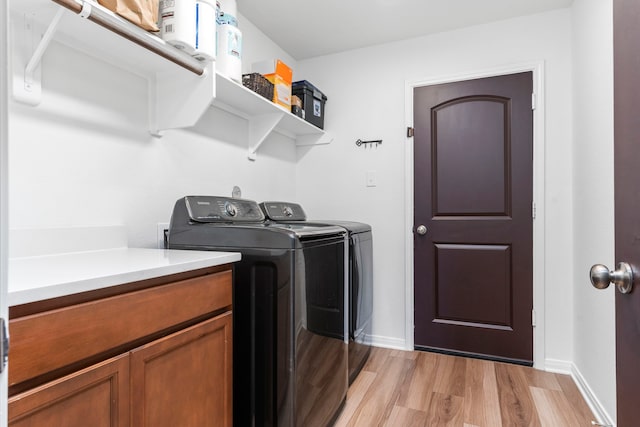 3221 Climbing Gardens Ct, Conroe, TX 77301 - washroom with washer and dryer, light wood-style floors, and baseboards