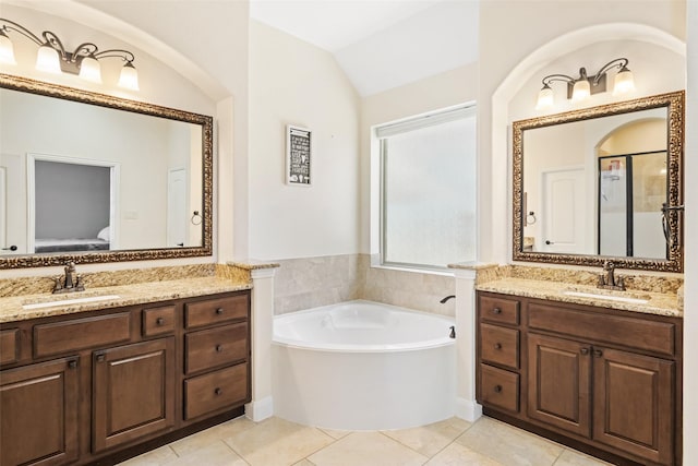 17726 Rough River Ct, Humble, TX 77346 - full bath with two vanities, a garden tub, tile patterned floors, lofted ceiling, and an enclosed shower