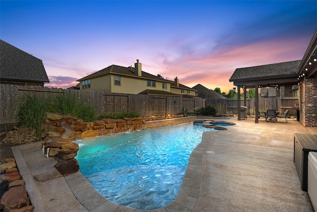 17726 Rough River Ct, Humble, TX 77346 - pool at dusk with a fenced backyard, a patio area, and a pool with connected hot tub