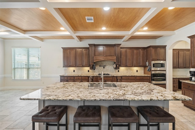 17726 Rough River Ct, Humble, TX 77346 - kitchen featuring appliances with stainless steel finishes, coffered ceiling, tasteful backsplash, recessed lighting, and a breakfast bar