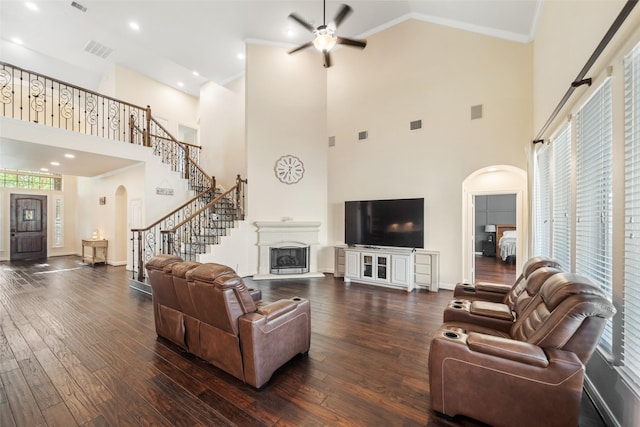 17726 Rough River Ct, Humble, TX 77346 - living room featuring arched walkways, a ceiling fan, dark wood-type flooring, ornamental molding, and plenty of natural light