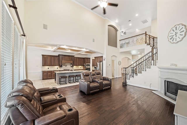 17726 Rough River Ct, Humble, TX 77346 - living area featuring a ceiling fan, arched walkways, a high ceiling, hardwood / wood-style floors, and baseboards