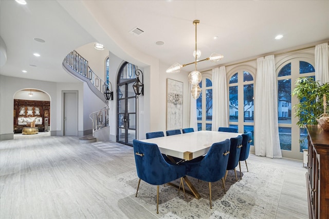 19 Ellicott Way, Sugar Land, TX 77479 - dining room featuring arched walkways, stairway, baseboards, light wood-style flooring, and recessed lighting