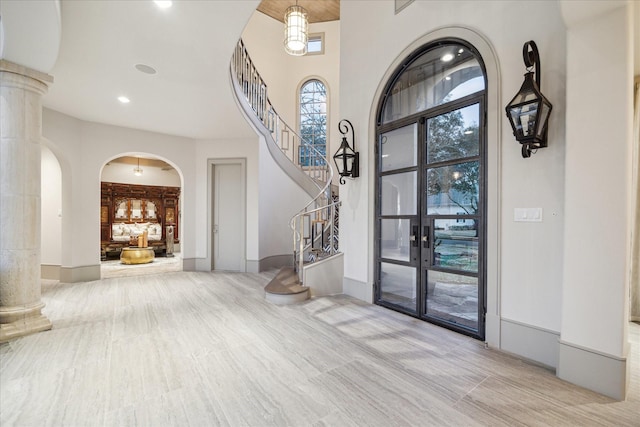 19 Ellicott Way, Sugar Land, TX 77479 - entryway with arched walkways, stairs, ornate columns, and a towering ceiling