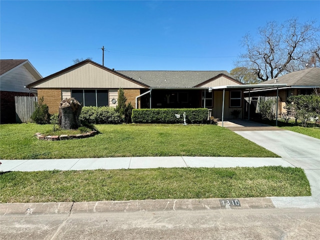 1310 Zapp Ln, Pasadena, TX 77502 - ranch-style home featuring a front yard, concrete driveway, an attached carport, and brick siding