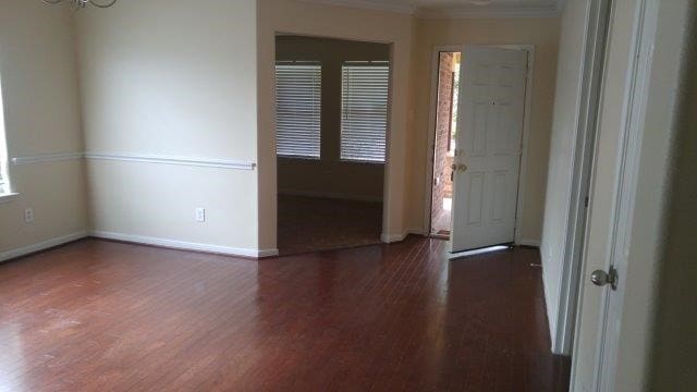2902 Winslow Forest Ln, Houston, TX 77047 - entryway with wood finished floors, baseboards, crown molding, and a chandelier