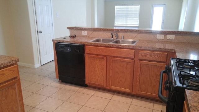 2902 Winslow Forest Ln, Houston, TX 77047 - kitchen with black appliances, a sink, light tile patterned floors, and brown cabinetry