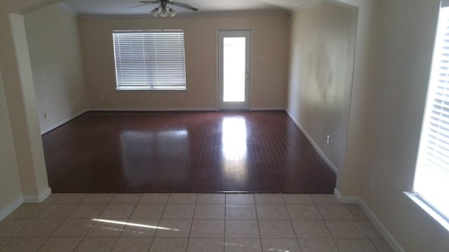 2902 Winslow Forest Ln, Houston, TX 77047 - empty room featuring crown molding, ceiling fan, baseboards, and tile patterned floors