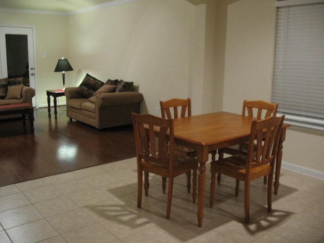 2902 Winslow Forest Ln, Houston, TX 77047 - dining area featuring crown molding, light tile patterned flooring, and baseboards