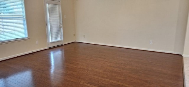 2902 Winslow Forest Ln, Houston, TX 77047 - spare room featuring dark wood-style flooring and baseboards