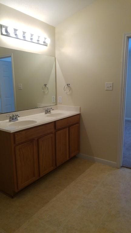 2902 Winslow Forest Ln, Houston, TX 77047 - bathroom featuring double vanity and baseboards