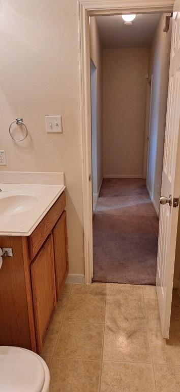 2902 Winslow Forest Ln, Houston, TX 77047 - bathroom with tile patterned floors, vanity, toilet, and baseboards