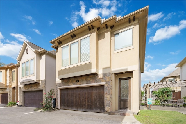 311 Gregg St, Houston, TX 77020 - townhome / multi-family property with stone siding, stucco siding, a garage, and concrete driveway
