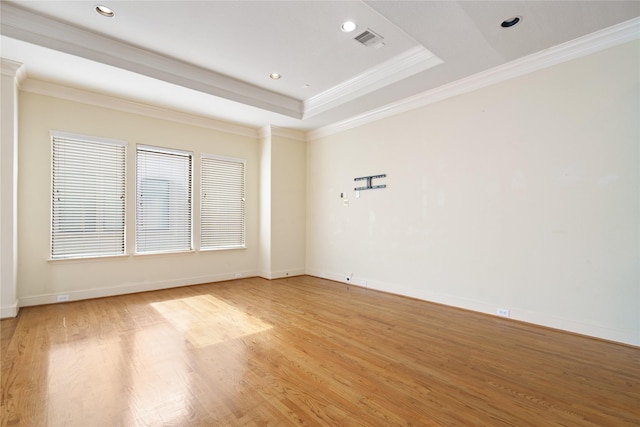 311 Gregg St, Houston, TX 77020 - unfurnished room with ornamental molding, light wood-style floors, recessed lighting, baseboards, and a tray ceiling