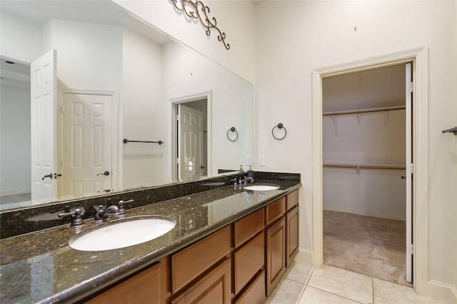 311 Gregg St, Houston, TX 77020 - full bathroom with tile patterned floors, double vanity, baseboards, and a spacious closet
