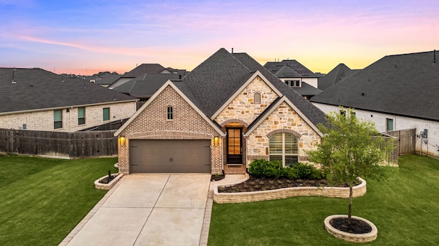 4107 Maple Glen Dr, Fulshear, TX 77441 - french country home featuring driveway, stone siding, roof with shingles, brick siding, and an attached garage