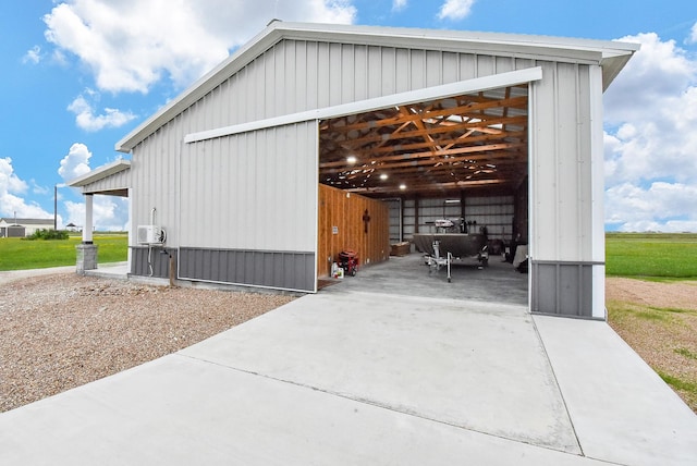263 Kingfish Ln, Palacios, TX 77465 - view of side of property featuring a pole building, an outbuilding, concrete driveway, and a detached garage
