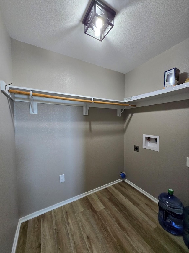 263 Kingfish Ln, Palacios, TX 77465 - clothes washing area featuring wood finished floors, hookup for an electric dryer, a textured ceiling, baseboards, and hookup for a washing machine