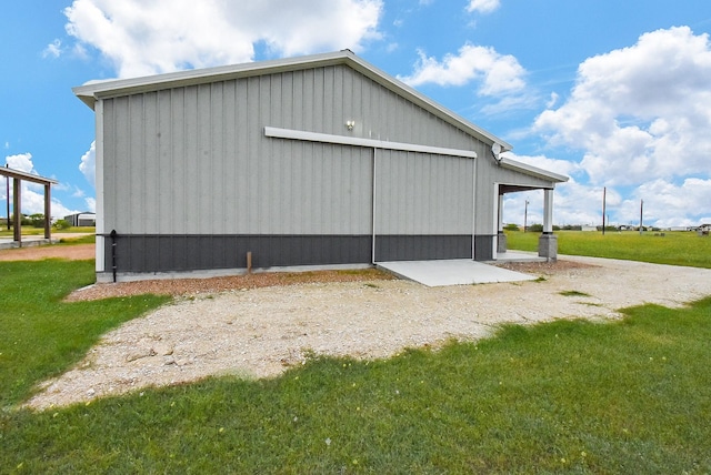 263 Kingfish Ln, Palacios, TX 77465 - view of property exterior with a yard, an outdoor structure, an outbuilding, and a detached garage