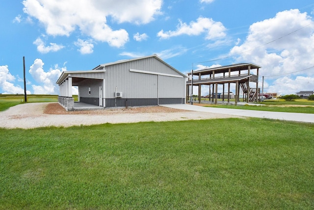 263 Kingfish Ln, Palacios, TX 77465 - view of side of property with a yard, an outdoor structure, a pole building, and stairway