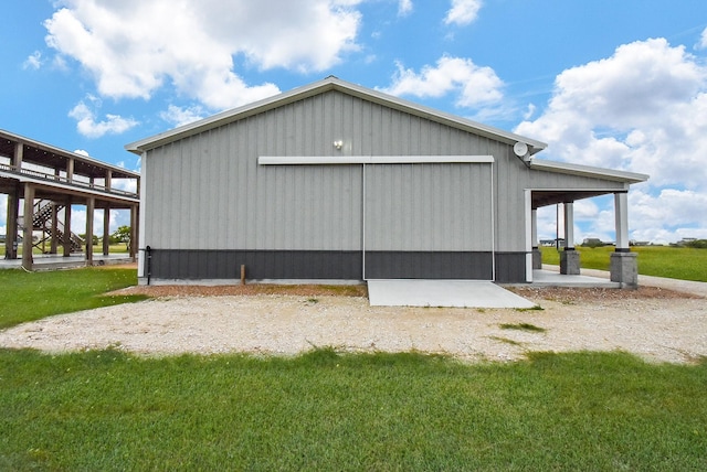 263 Kingfish Ln, Palacios, TX 77465 - view of side of home with a lawn, stairway, an outbuilding, and a pole building