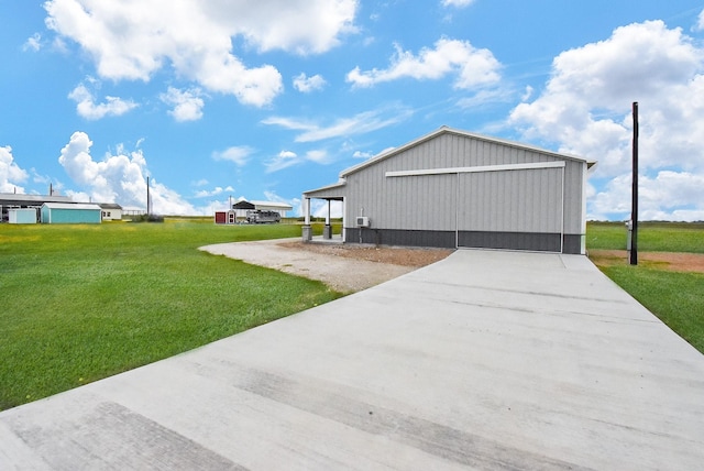 263 Kingfish Ln, Palacios, TX 77465 - view of home's exterior featuring a yard, an outbuilding, a pole building, a detached garage, and concrete driveway