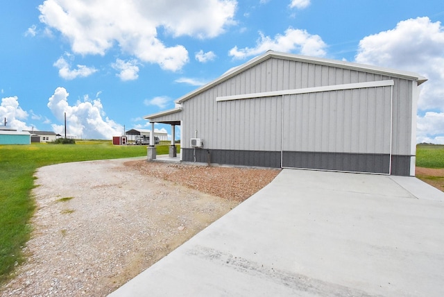 263 Kingfish Ln, Palacios, TX 77465 - view of side of property featuring a garage, a yard, an outdoor structure, and board and batten siding