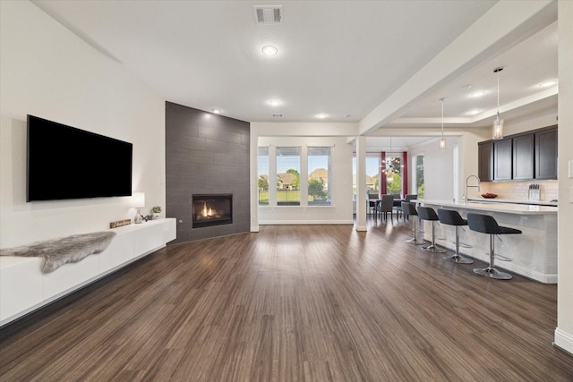 19534 Juniper Breeze Ln, Spring, TX 77379 - living area with dark wood-type flooring, a fireplace, baseboards, and recessed lighting