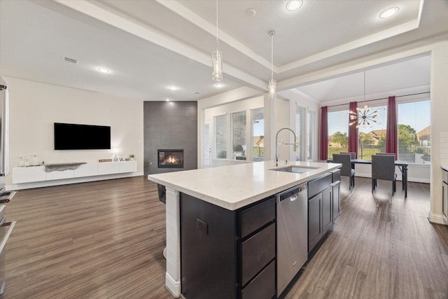 19534 Juniper Breeze Ln, Spring, TX 77379 - kitchen featuring a sink, stainless steel dishwasher, a large fireplace, a chandelier, and decorative light fixtures