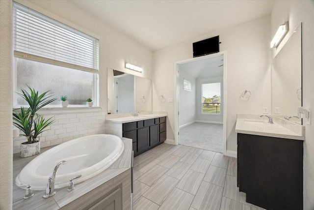 19534 Juniper Breeze Ln, Spring, TX 77379 - full bath featuring two vanities, a garden tub, and baseboards